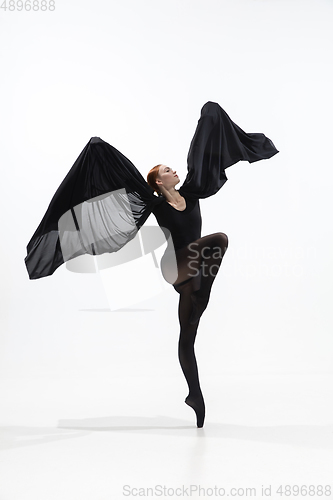 Image of Young and graceful ballet dancer in minimal black style isolated on white studio background