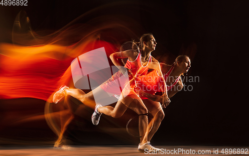 Image of Professional female tennis player isolated on black studio background in mixed light