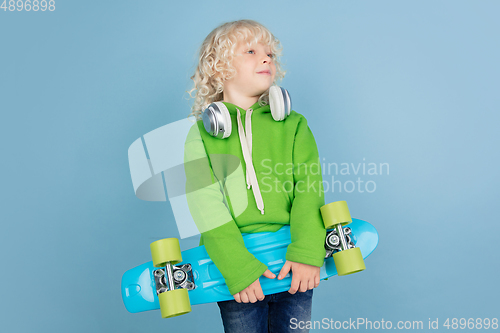 Image of Portrait of beautiful caucasian little boy isolated on blue studio background