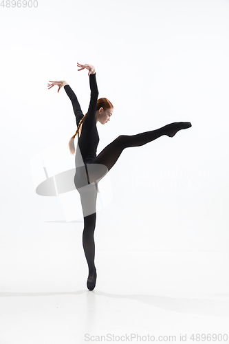 Image of Young and graceful ballet dancer in minimal black style isolated on white studio background