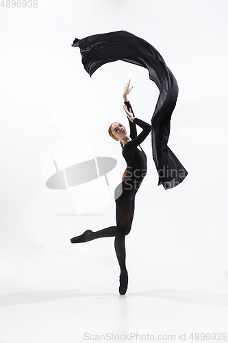 Image of Young and graceful ballet dancer in minimal black style isolated on white studio background