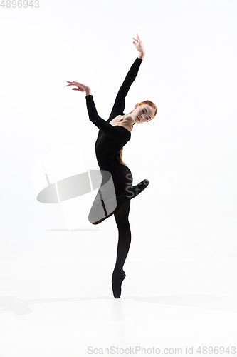 Image of Young and graceful ballet dancer in minimal black style isolated on white studio background