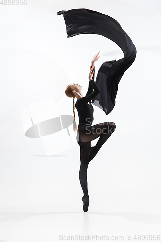 Image of Young and graceful ballet dancer in minimal black style isolated on white studio background