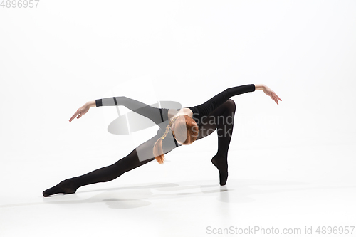 Image of Young and graceful ballet dancer in minimal black style isolated on white studio background