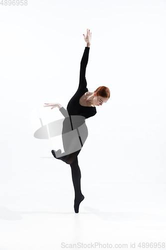 Image of Young and graceful ballet dancer in minimal black style isolated on white studio background