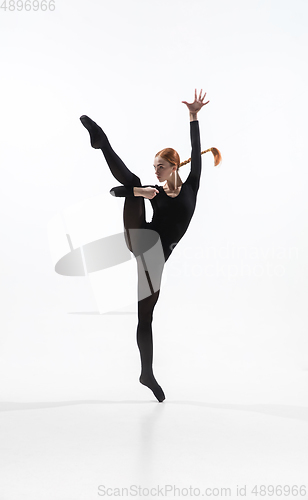 Image of Young and graceful ballet dancer in minimal black style isolated on white studio background