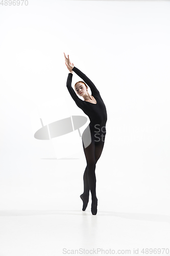 Image of Young and graceful ballet dancer in minimal black style isolated on white studio background