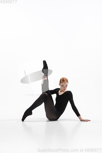 Image of Young and graceful ballet dancer in minimal black style isolated on white studio background