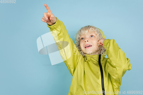 Image of Portrait of beautiful caucasian little boy isolated on blue studio background