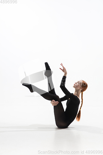 Image of Young and graceful ballet dancer in minimal black style isolated on white studio background