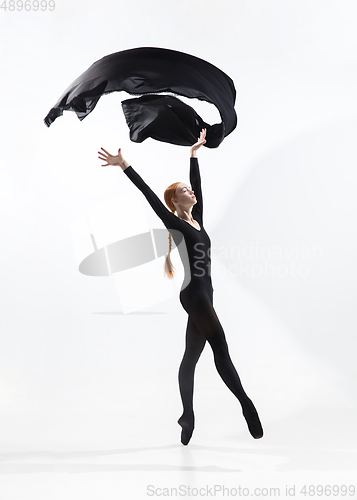 Image of Young and graceful ballet dancer in minimal black style isolated on white studio background