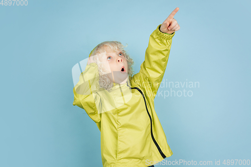 Image of Portrait of beautiful caucasian little boy isolated on blue studio background
