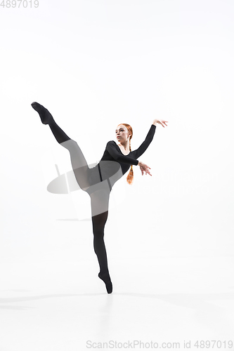 Image of Young and graceful ballet dancer in minimal black style isolated on white studio background