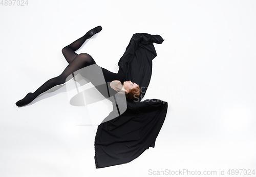 Image of Young and graceful ballet dancer in minimal black style isolated on white studio background