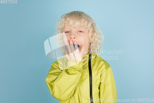 Image of Portrait of beautiful caucasian little boy isolated on blue studio background