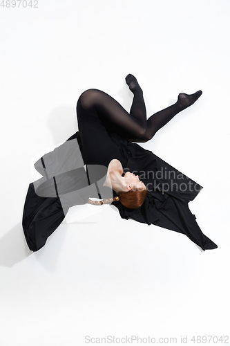 Image of Young and graceful ballet dancer in minimal black style isolated on white studio background