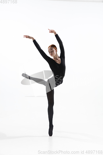 Image of Young and graceful ballet dancer in minimal black style isolated on white studio background