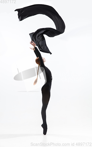 Image of Young and graceful ballet dancer in minimal black style isolated on white studio background