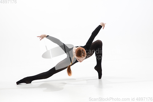 Image of Young and graceful ballet dancer in minimal black style isolated on white studio background