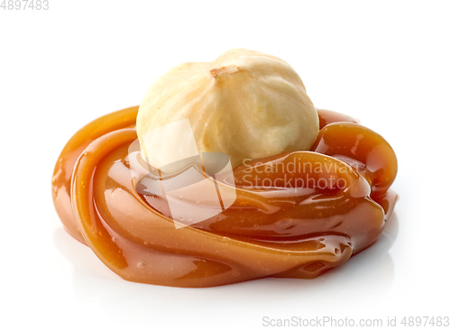 Image of hazelnut in melted caramel