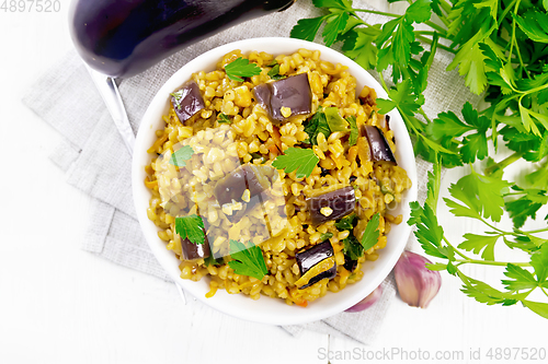 Image of Bulgur with eggplant in bowl on board top