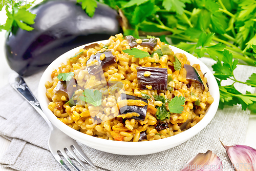 Image of Bulgur with eggplant in bowl on white board