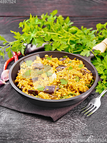 Image of Bulgur with eggplant in pan on table