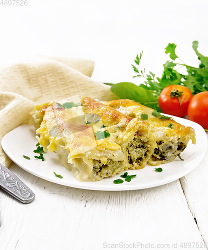 Image of Cannelloni with curd and spinach in plate on table