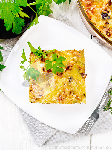 Image of Casserole of meat and eggplant in plate on light board top