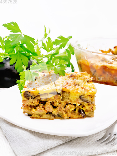 Image of Casserole of meat and eggplant in plate on table