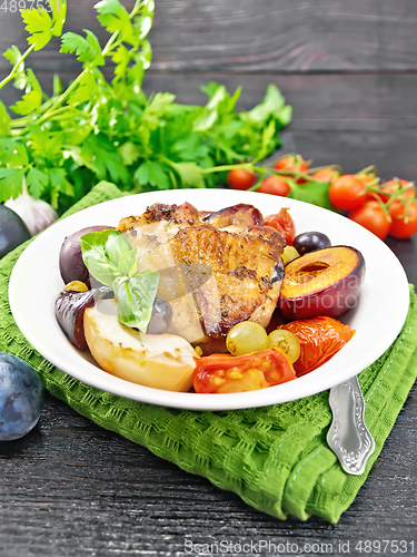 Image of Chicken with fruits and tomatoes in plate on napkin