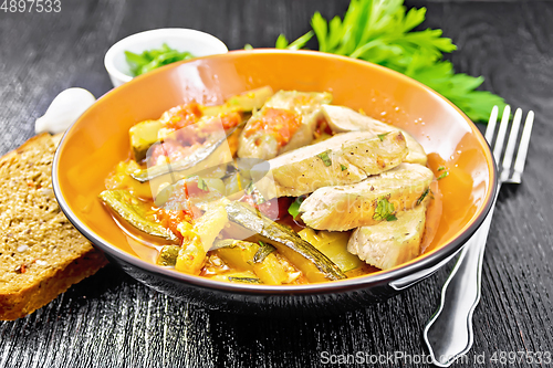 Image of Chicken with stewed zucchini in plate on board