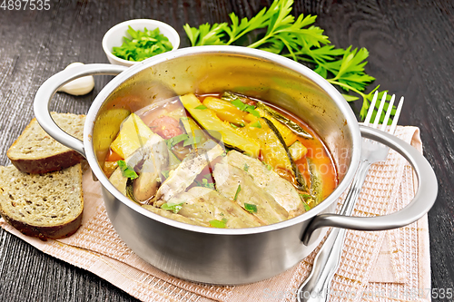 Image of Chicken with stewed zucchini in saucepan on board
