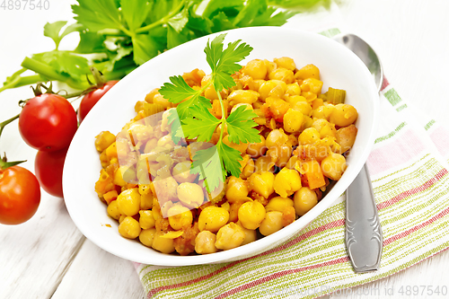 Image of Chickpeas stewed with vegetables in plate on white board