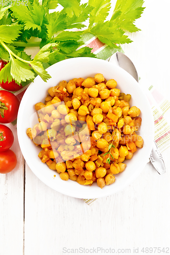 Image of Chickpeas with vegetables stewed in plate on board top