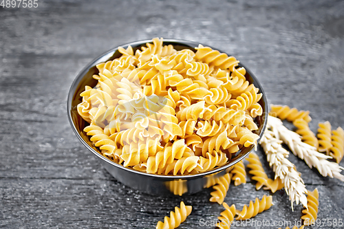 Image of Fusilli whole grain in bowl on dark board