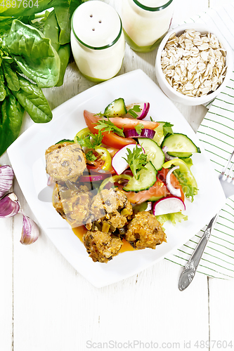 Image of Meatballs with spinach and oatmeal on light board top