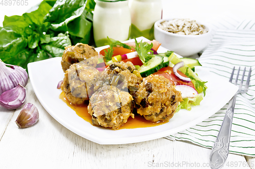 Image of Meatballs with spinach and oatmeal on wooden board