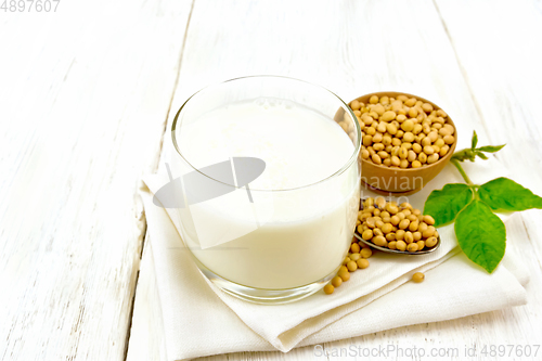 Image of Milk soy in glass with leaf on light board