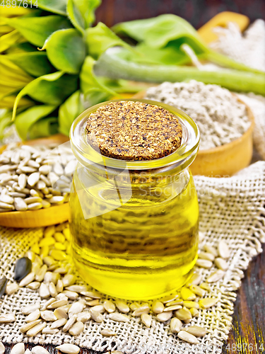 Image of Oil sunflower in jar with flour on burlap