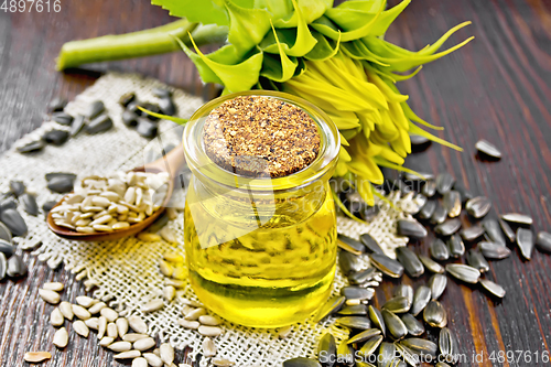 Image of Oil sunflower in jar with flower on board