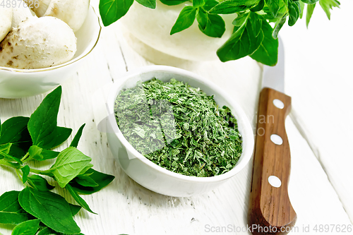 Image of Oregano dried in bowl on wooden table