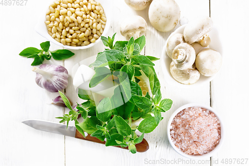 Image of Oregano fresh in mortar on board top