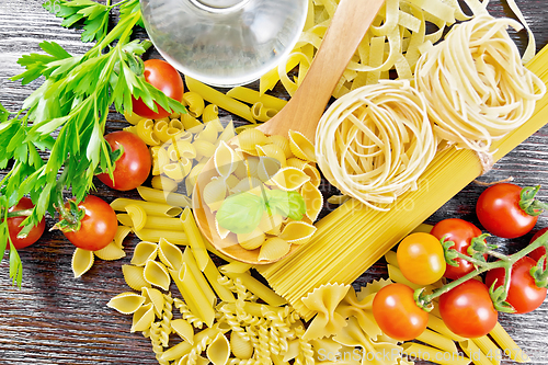 Image of Pasta different with oil and tomatoes on board top