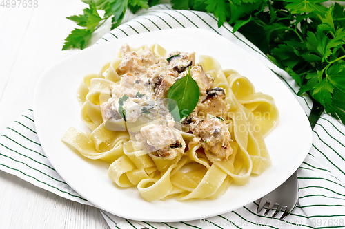 Image of Pasta with salmon in cream on light board