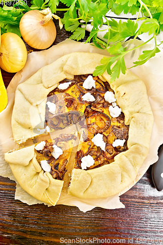 Image of Pie with pumpkin and onions on board top