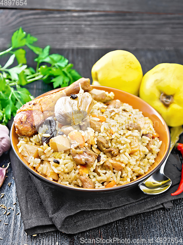 Image of Pilaf with duck and quince in plate on napkin