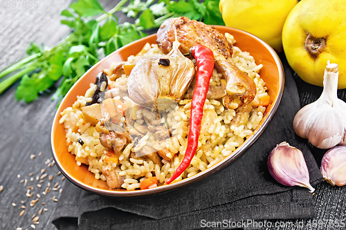 Image of Pilaf with duck and quince in plate on table