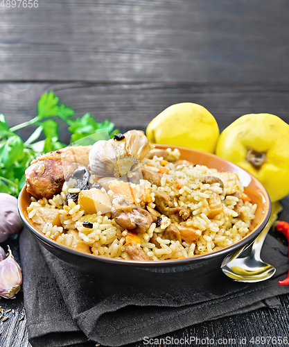 Image of Pilaf with duck and quince in plate on towel