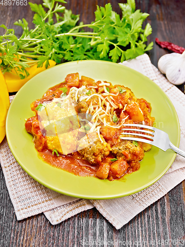 Image of Porridge corn with meat and vegetables in plate on napkin